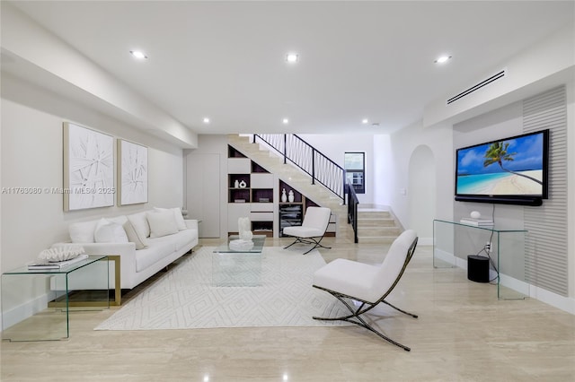 living room featuring arched walkways, stairway, recessed lighting, and visible vents