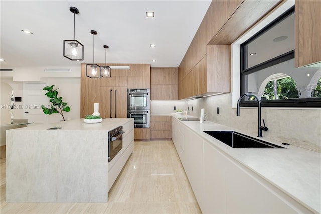 kitchen featuring double oven, a center island, modern cabinets, and a sink