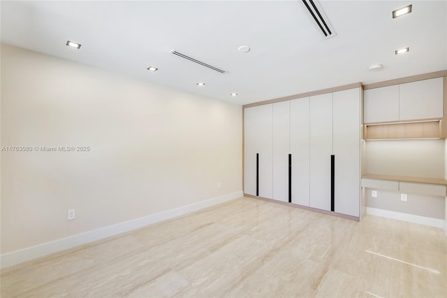 unfurnished room with visible vents and baseboards