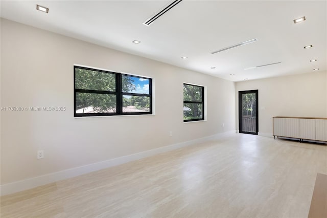 spare room with recessed lighting, visible vents, and baseboards