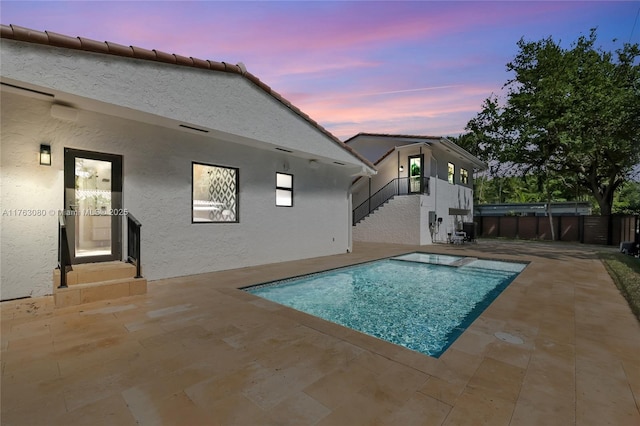 view of swimming pool featuring stairs, fence, a patio area, and a fenced in pool