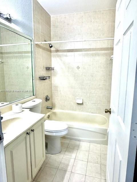 full bathroom featuring tile patterned floors, toilet, vanity, and shower / tub combination