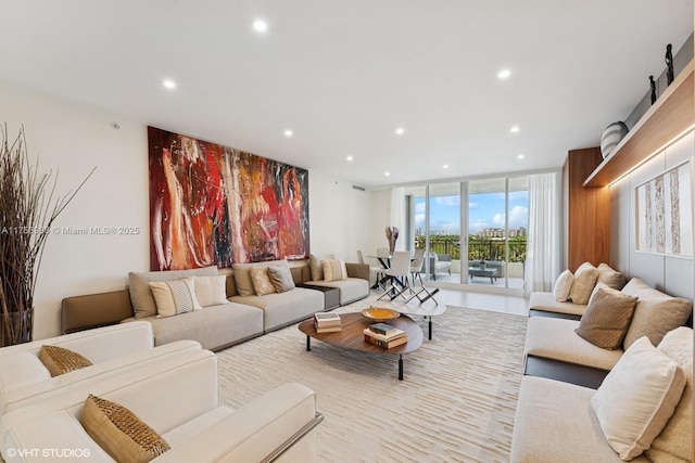 living area featuring recessed lighting and a wall of windows