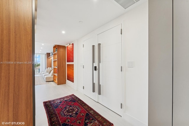 hallway featuring recessed lighting and visible vents