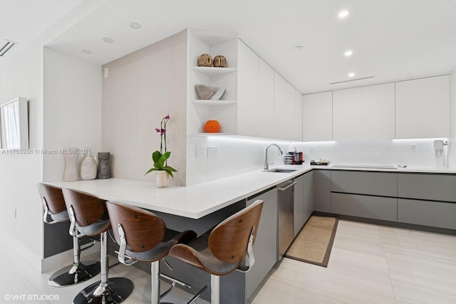 kitchen featuring open shelves, gray cabinetry, modern cabinets, and a sink