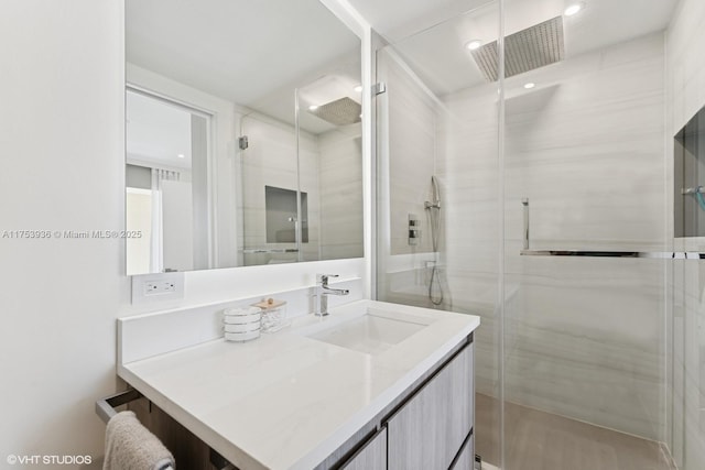 full bath with vanity and a shower stall