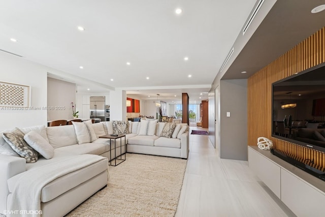 living area featuring visible vents and recessed lighting