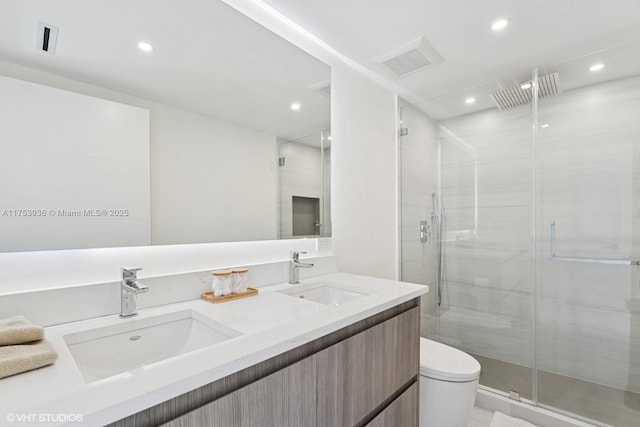 full bathroom featuring recessed lighting, a stall shower, toilet, and a sink