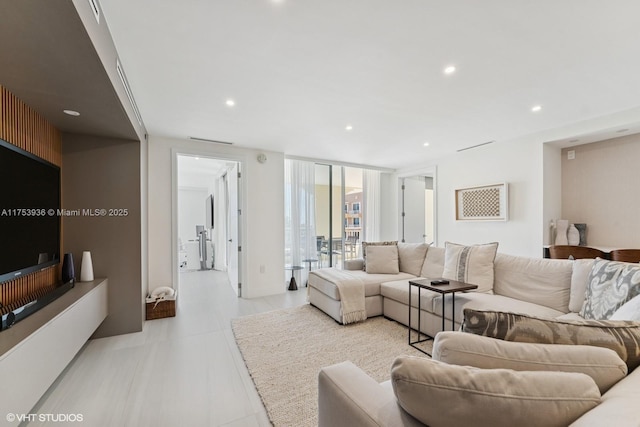 living room with visible vents, recessed lighting, and expansive windows