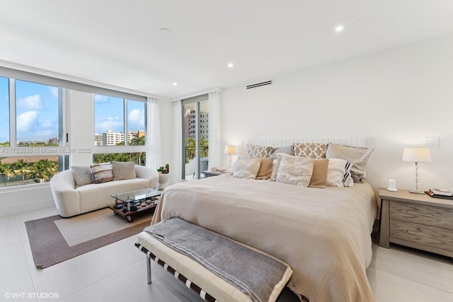 bedroom with recessed lighting and access to outside