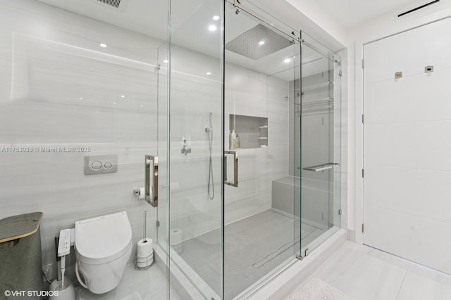 full bathroom with visible vents, a stall shower, tile patterned flooring, tile walls, and toilet