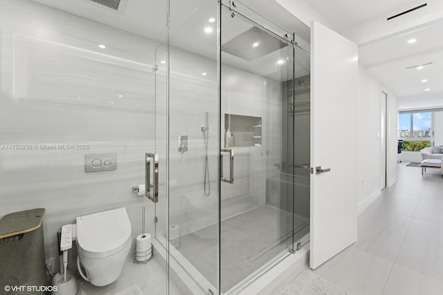 full bathroom featuring tile patterned floors, a shower stall, toilet, and tile walls