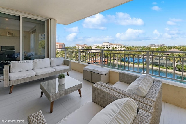 balcony featuring an outdoor hangout area and a water view