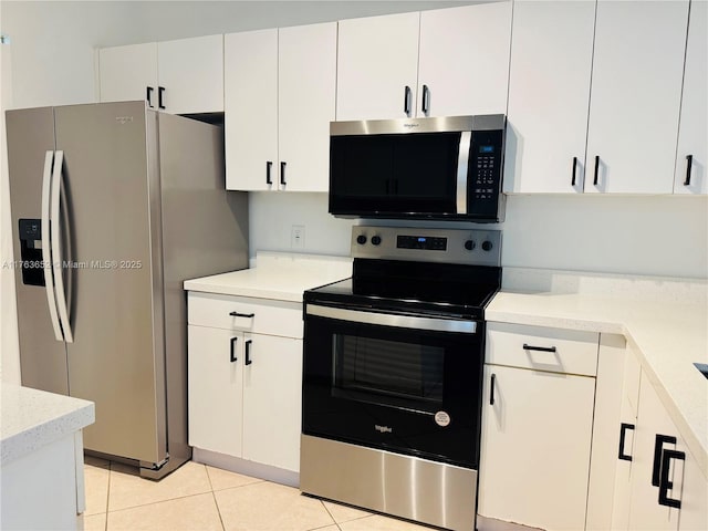 19555 E Country Club Dr Unit 8108, Aventura, FL 33180 - kitchen with light tile patterned flooring, white cabinetry, light countertops, and stainless steel appliances