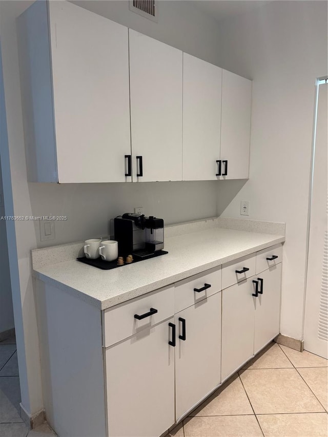 19555 E Country Club Dr Unit 8108, Aventura, FL 33180 - kitchen featuring white cabinetry, light countertops, light tile patterned flooring, and visible vents