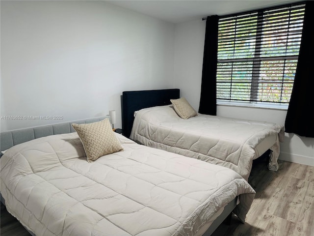19555 E Country Club Dr Unit 8108, Aventura, FL 33180 - bedroom featuring baseboards and wood finished floors