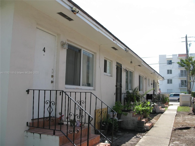 view of side of property with stucco siding