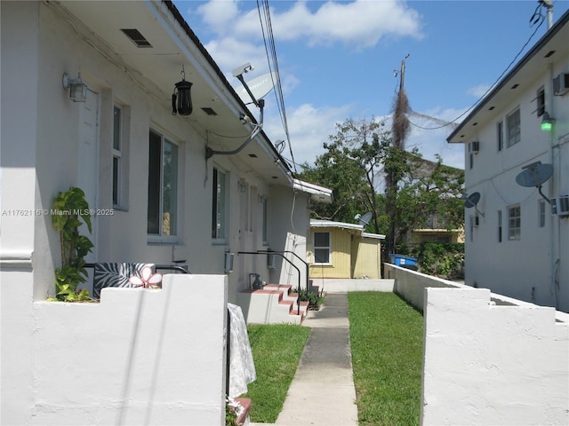 view of home's exterior featuring stucco siding and fence