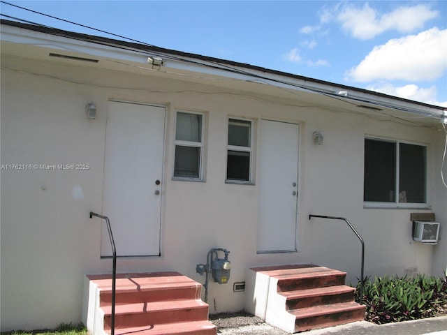 view of exterior entry featuring stucco siding