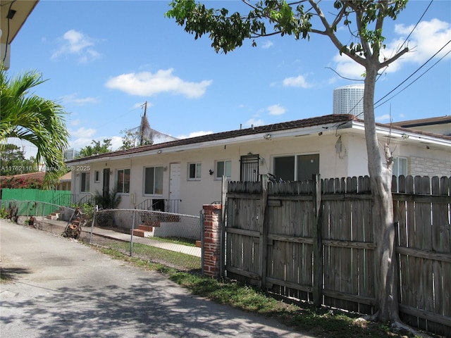 exterior space featuring a fenced front yard and stucco siding