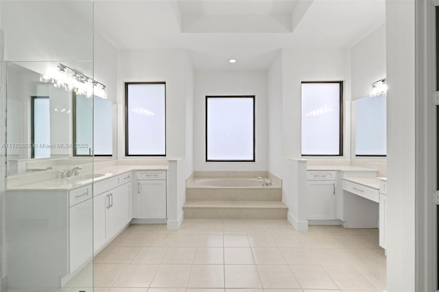 full bathroom featuring tile patterned flooring, a garden tub, vanity, and a raised ceiling