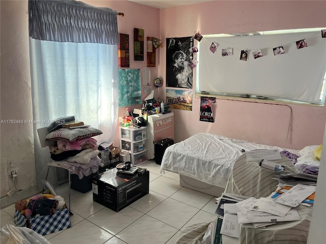 bedroom with light tile patterned flooring