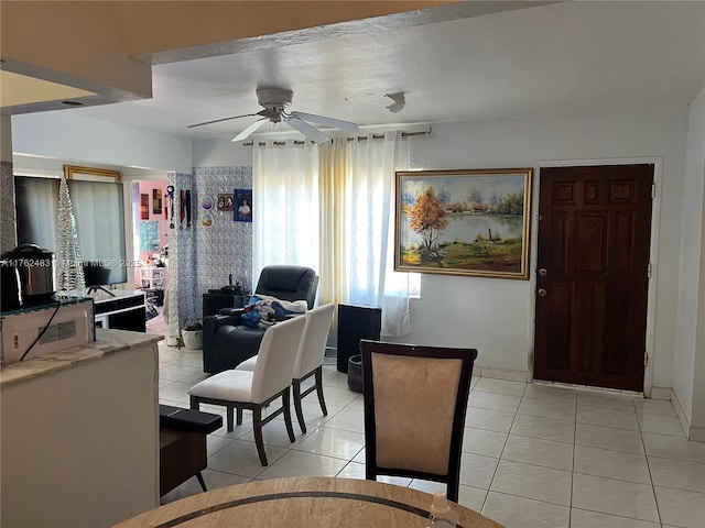 dining space with light tile patterned floors and a ceiling fan