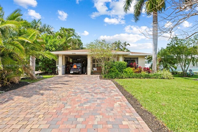 2395 SE 6th St, Pompano Beach, FL 33062 - single story home with a carport, a front yard, and decorative driveway