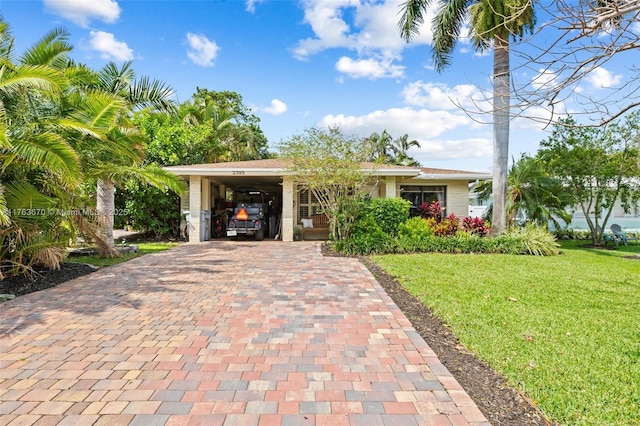2395 SE 6th St, Pompano Beach, FL 33062 - ranch-style home featuring a front yard, a carport, and decorative driveway