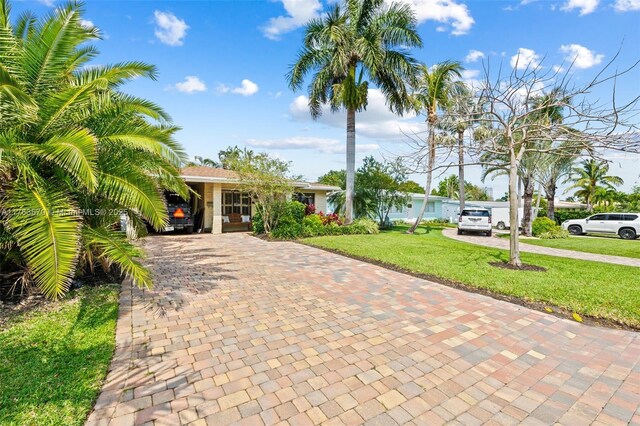 2395 SE 6th St, Pompano Beach, FL 33062 - view of front facade with a front yard and decorative driveway