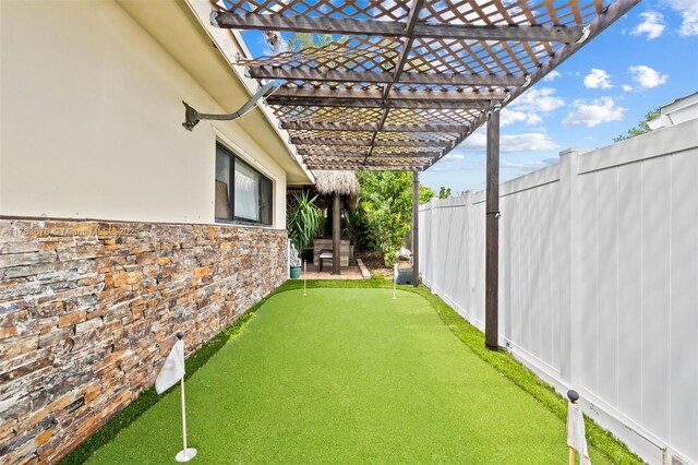 2395 SE 6th St, Pompano Beach, FL 33062 - view of yard with a pergola and a fenced backyard