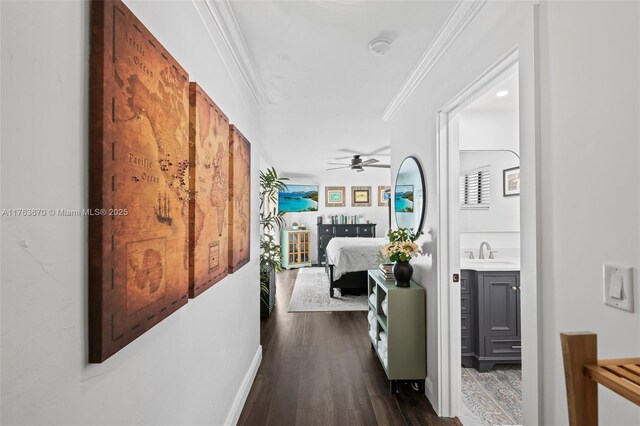 2395 SE 6th St, Pompano Beach, FL 33062 - hallway with crown molding, a sink, and dark wood-style floors