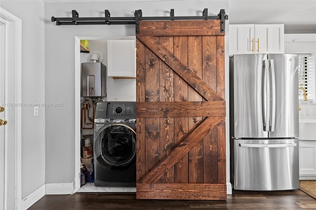 2395 SE 6th St, Pompano Beach, FL 33062 - laundry room with a barn door, water heater, washer / dryer, and cabinet space