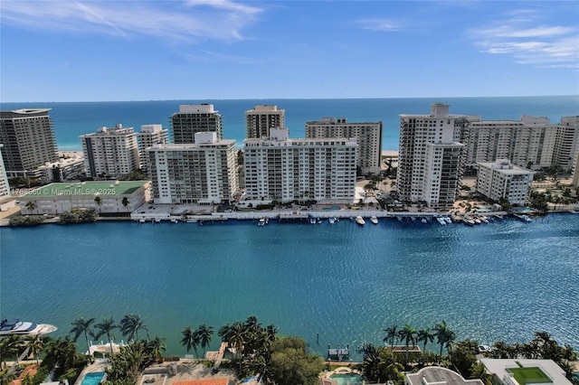 birds eye view of property with a water view and a view of city