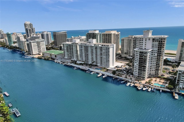 birds eye view of property with a water view and a city view