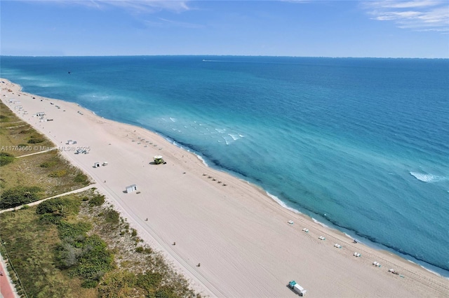 drone / aerial view with a view of the beach and a water view