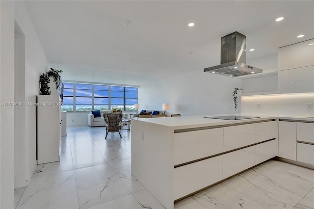 kitchen with white cabinetry, open floor plan, exhaust hood, and marble finish floor