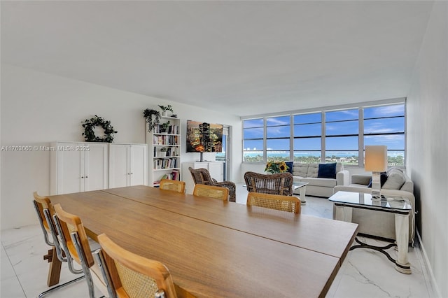 dining area with marble finish floor