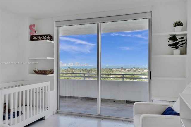 bedroom with a view of city, marble finish floor, and a closet