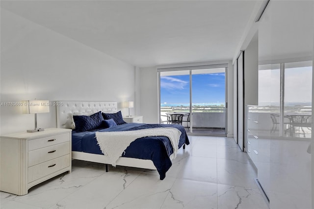 bedroom with marble finish floor, access to exterior, and floor to ceiling windows