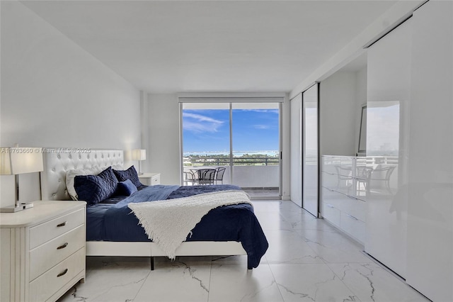 bedroom with expansive windows, marble finish floor, and access to outside