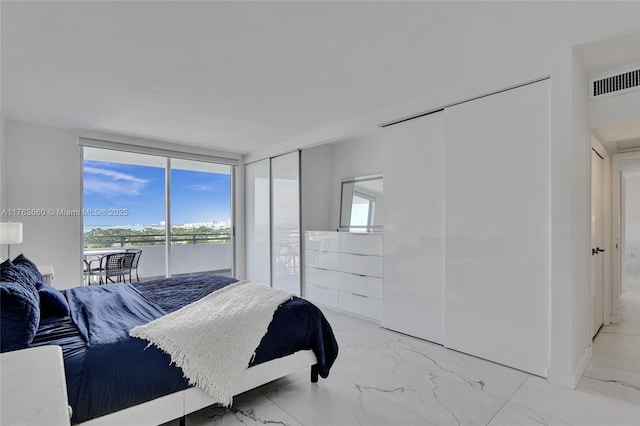 bedroom with visible vents, multiple windows, marble finish floor, and floor to ceiling windows