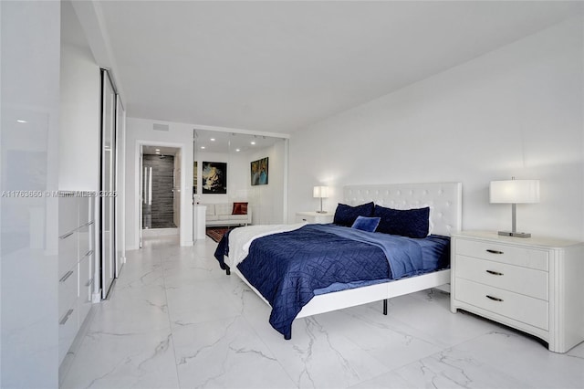 bedroom featuring visible vents, marble finish floor, and connected bathroom