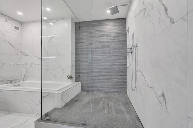 full bath with tile walls, a garden tub, visible vents, and a marble finish shower