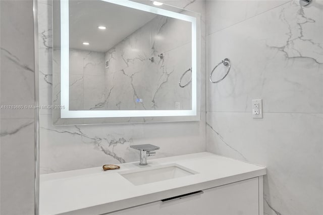 bathroom featuring recessed lighting, tile walls, and vanity