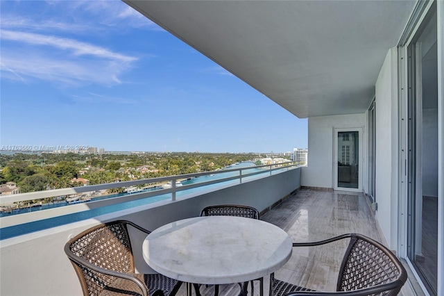 balcony featuring a view of city and outdoor dining area