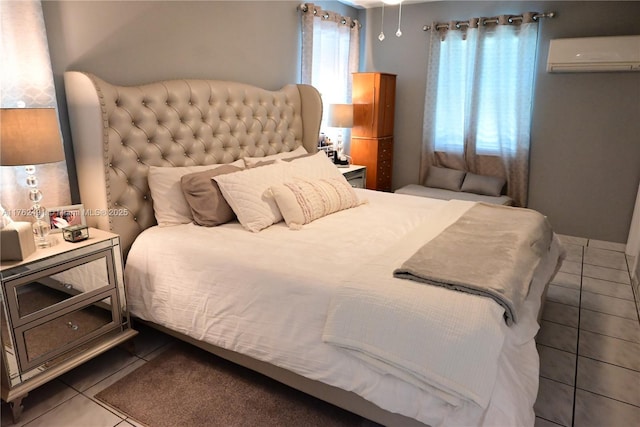 bedroom featuring tile patterned floors and a wall unit AC