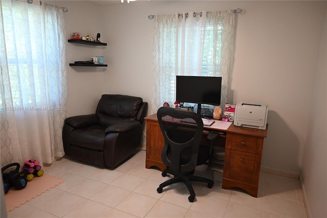 office space featuring baseboards and light tile patterned flooring