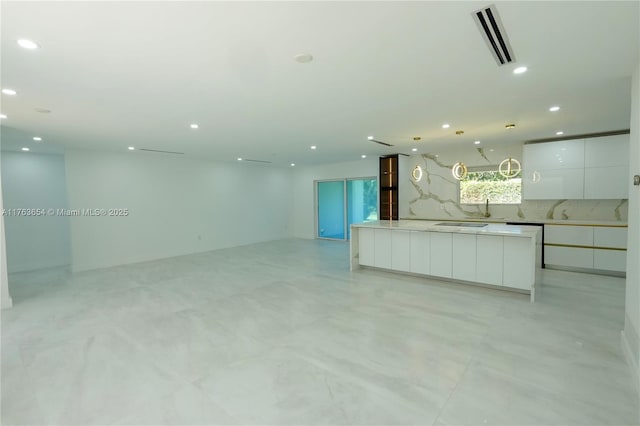 kitchen featuring visible vents, modern cabinets, recessed lighting, white cabinets, and hanging light fixtures