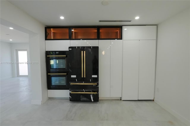 kitchen with recessed lighting, black appliances, white cabinets, a warming drawer, and modern cabinets